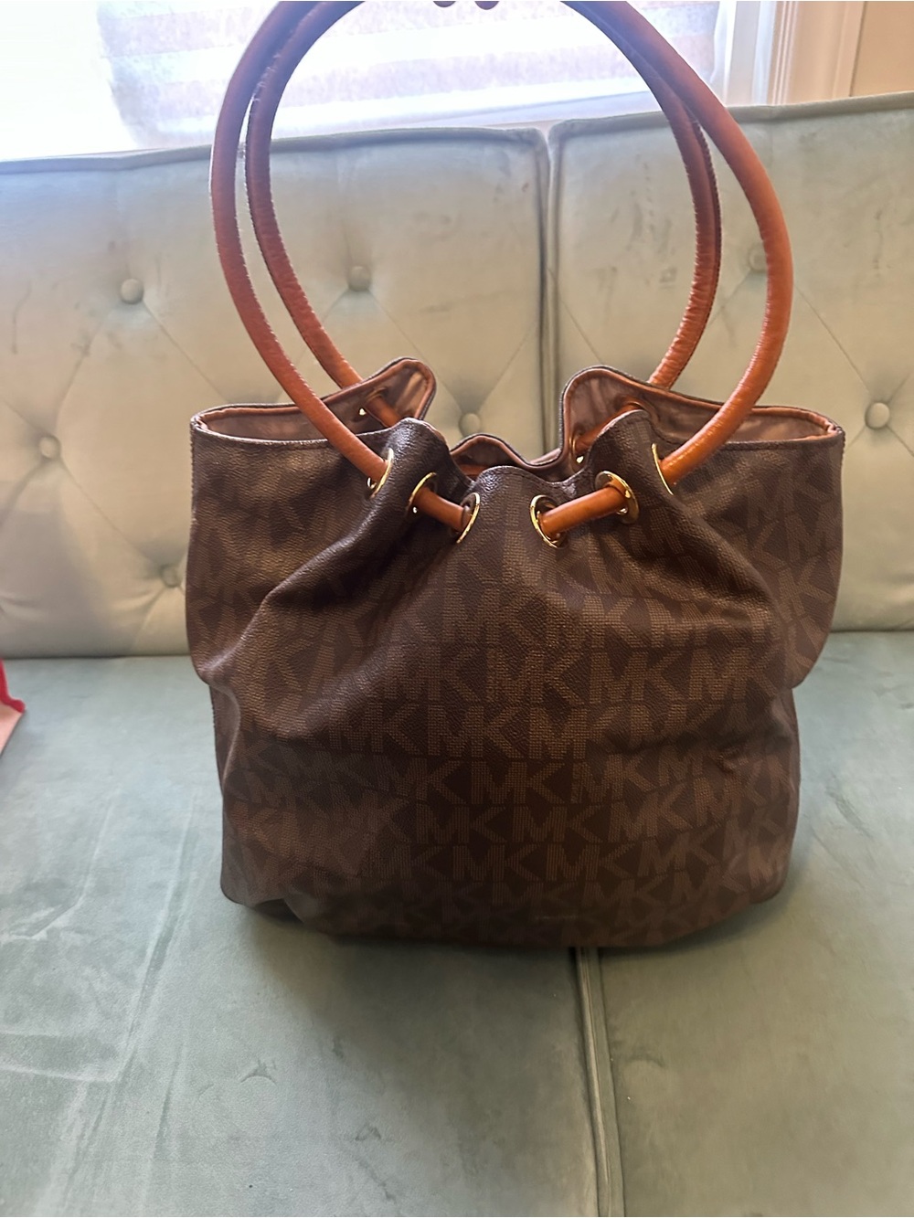 Michael Kors Brown Monogram Bucket Bag with Tassel Charm - Picture 2 of 3